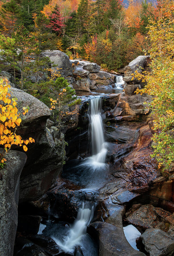 Screw Auger Falls surrounded by vivid fall color in Grafton Notch State Park Maine